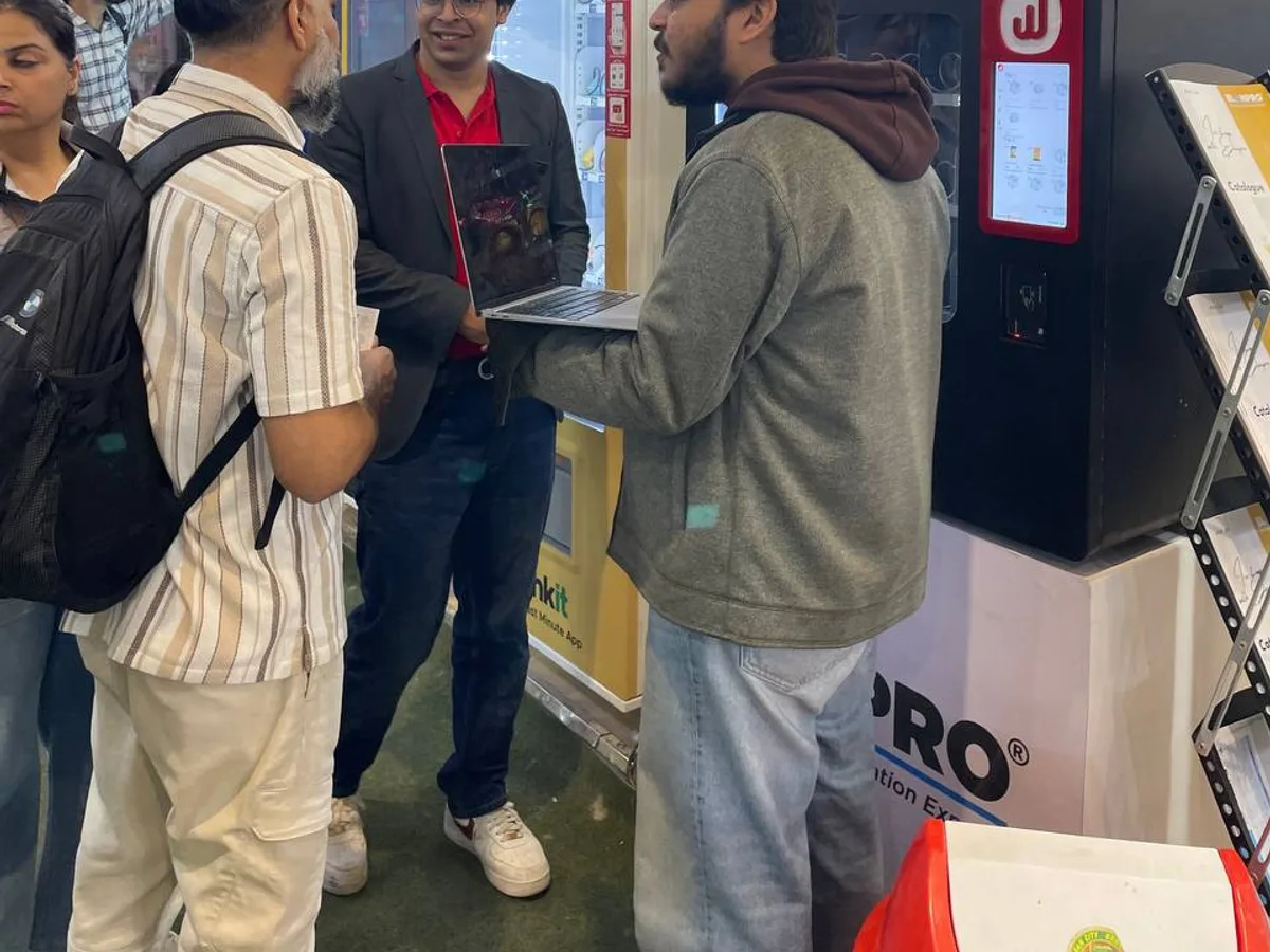 Employee tapping a contactless card and phone at an office vending machine
