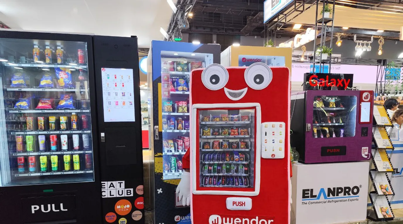 Office vending machine stocked with fresh fruit, nuts, yogurt, and healthy snacks