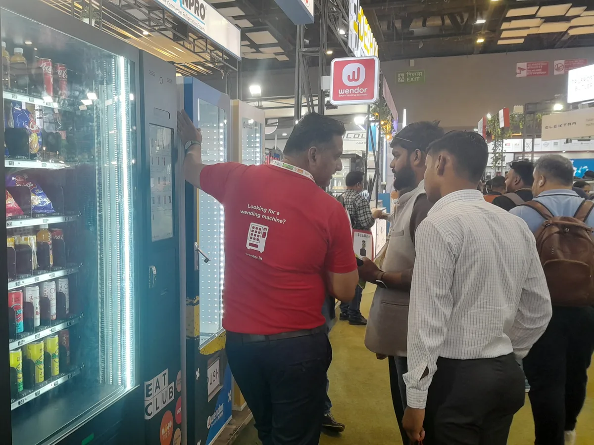Technician inspecting the payment system and components of a used vending machine