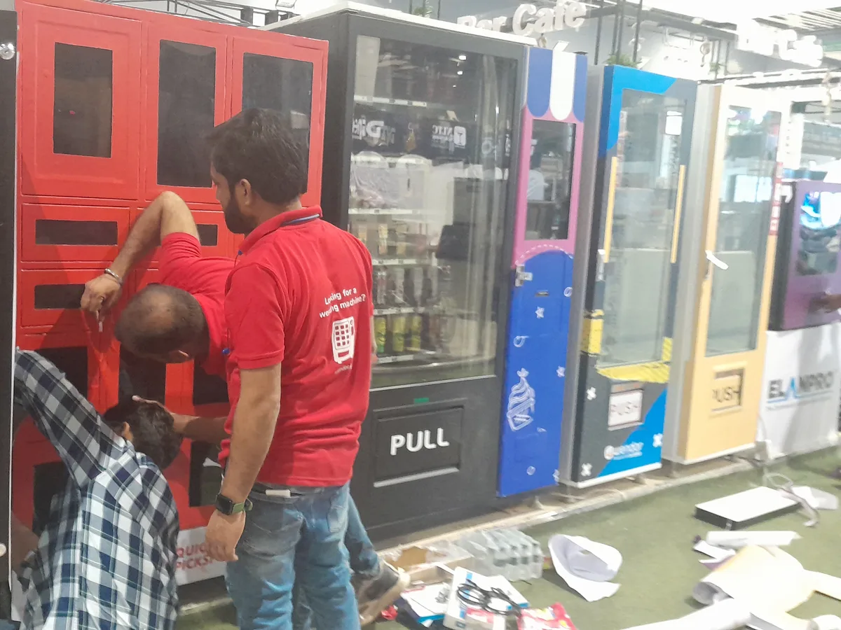 Organized kit of essential vending machine spare parts on a workbench