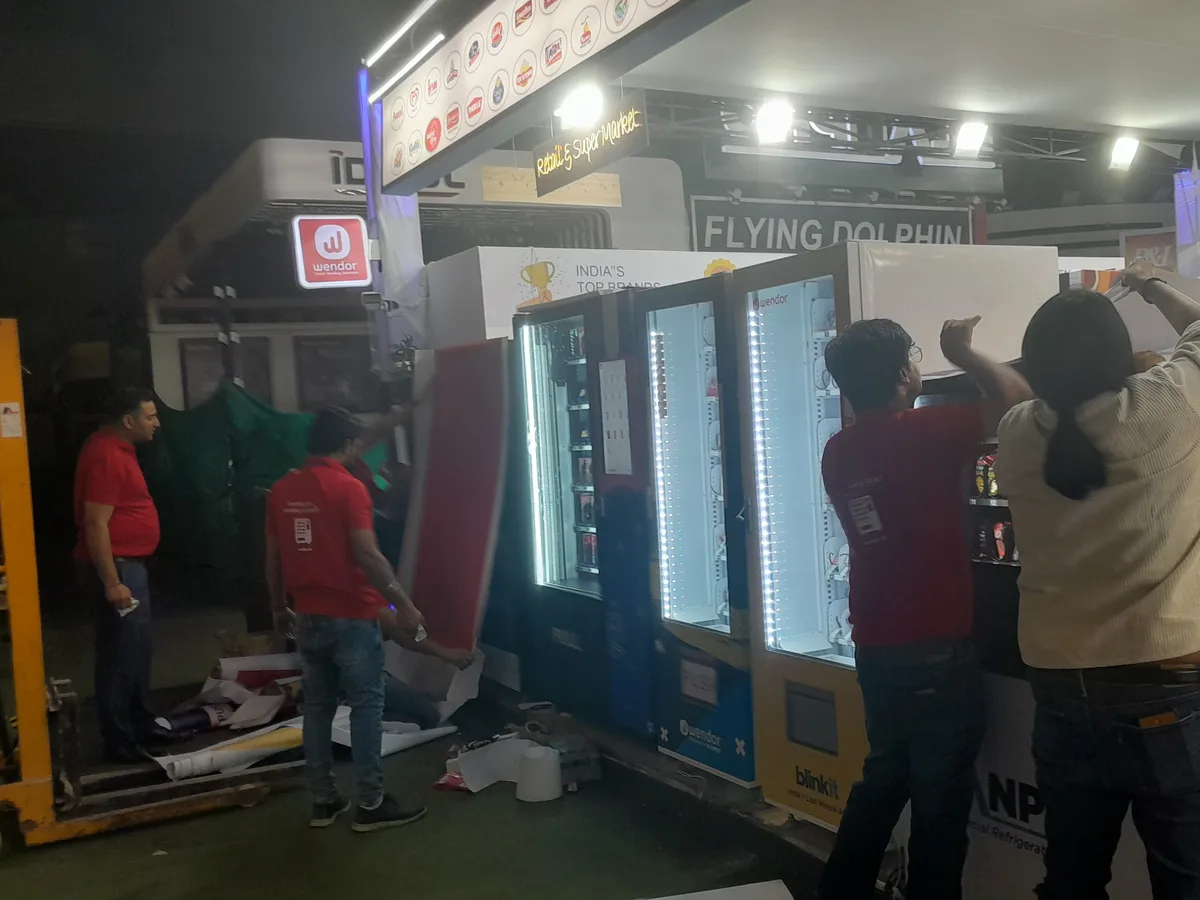 Weatherproof vending machine within a residential property boundary on a busy street