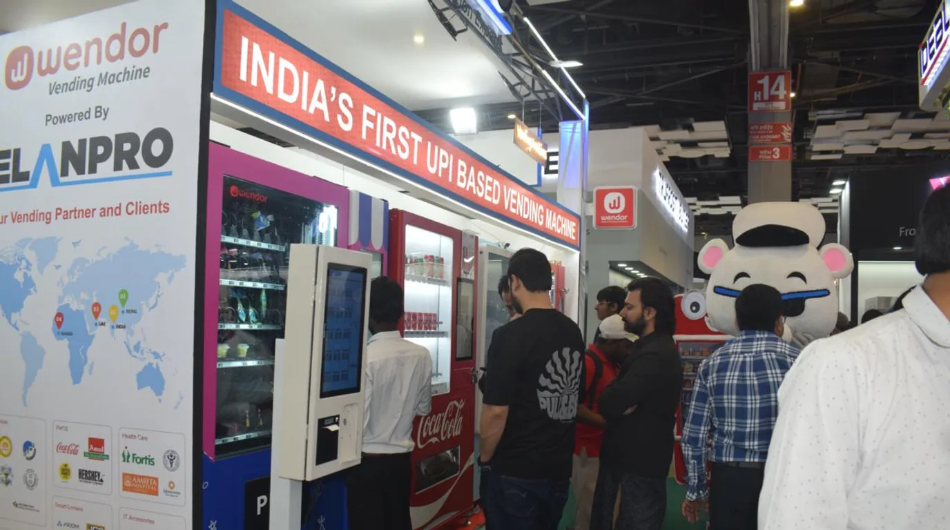 Tech-savvy people confidently using modern vending machines in urban India