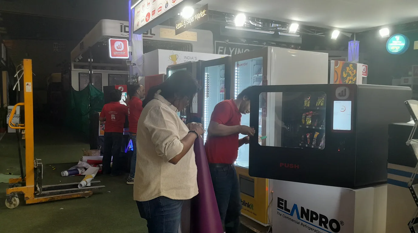 Customer quickly buying multiple items from a fast modern vending machine