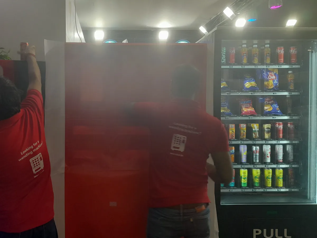 Price-conscious shopper weighing the cost of a vending machine snack