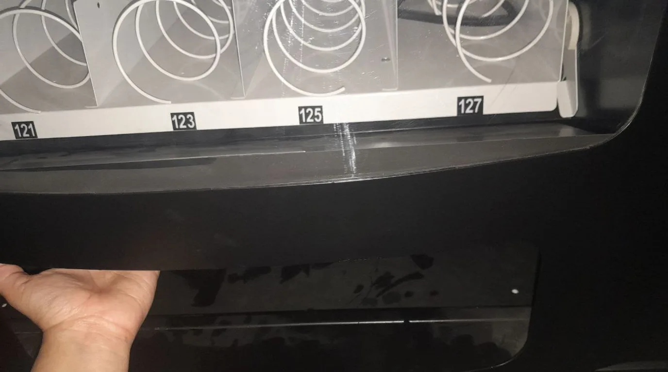 Prepared operator running a well-stocked modern vending machine successfully